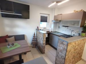 a kitchen with a counter and a table in a room at Pension Dietrich in Dobel +15 photos
