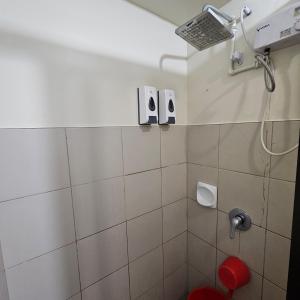 a bathroom with a shower with a shower head at Avida towers davao condo 6thfloor in Davao City +8 photos