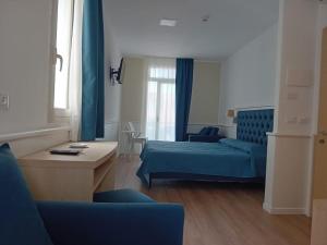 a living room with a blue bed and a couch at Villa Athena in Giardini Naxos