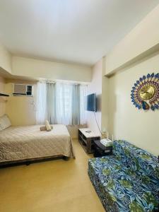 a hotel room with two beds and a window at Avida towers davao condo 6thfloor in Davao City