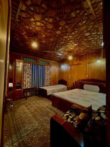 a room with two beds and a couch in it at White blossom in Srinagar