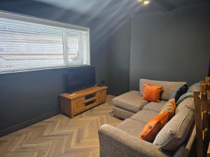 a living room with a couch and a window at The Resting Place in Aberystwyth