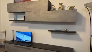 a living room with a tv on a wall at Tarvisium Apartment in Treviso