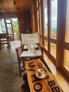a chair and a table with a coffee cup on it at Coffee Myhome in Xuan An +49 photos