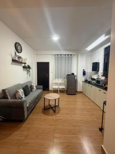 a living room with a couch and a kitchen at The Olive Inn in Shillong