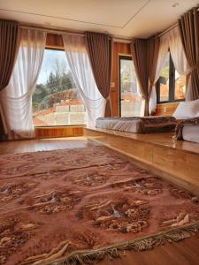 a bedroom with a large bed and a large rug at Coffee Myhome in Xuan An