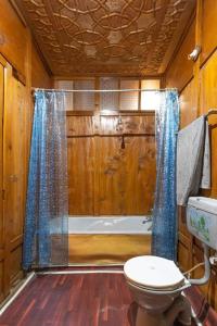 a bathroom with a toilet and a bath tub at White blossom in Srinagar +56 photos