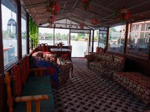 a room with couches and a table in a boat at White blossom in Srinagar