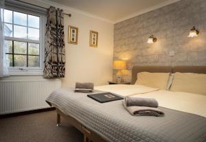a bedroom with a bed with a laptop on it at The Old Inn in Gairloch