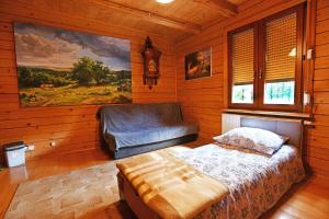 a bedroom with a bed in a wooden room at Apartamenty Pod Gruszką in Tarnawa Górna