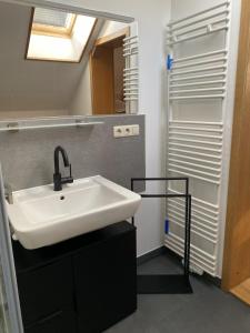 a bathroom with a sink and a shower at Appartements am Schlossberg in Starnberg +35 photos