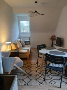 a living room with a couch and a table at Proche parc 3 curés in Coatéval