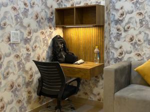 a room with a desk and a chair and a couch at Premium Studio Appartment in Māripat