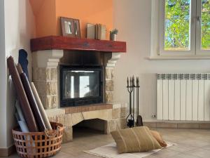 a living room with a fireplace with a television at Dimora dei Passi Lenti in Montegranaro