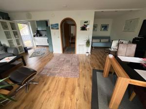 a living room with wooden floors and a dining room at FeWo Edelweiß Jäger in Nesselwang