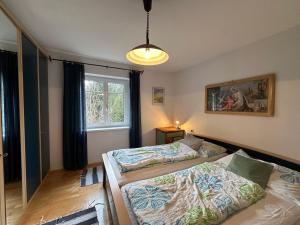 a bedroom with two beds and a window at Ferienhaus im Wald in Edelschrott
