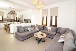 a living room with a couch and a table at Villa Katerina - Between sea & mountain in Kalymnos