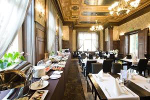 a dining room with long tables and chairs at Platinum Palace Boutique Hotel & SPA in Wrocław