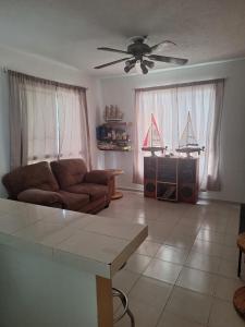 a living room with a couch and a table at Comfortable and nice house in Caucel in Mérida