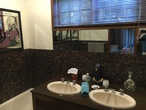 a bathroom with two sinks and a mirror and a tub at Kentia Palms in Old Reynella +18 photos