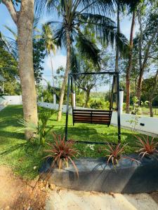 a swing in a park with palm trees at Golden Breeze Mirissa in Kamburugamuwa +6 photos
