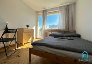a bedroom with a bed and a large window at Array Room - 5 Minutes to Sopot Molo & Seaside in Sopot