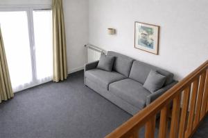 a living room with a couch and a window at Les Lilas Serviced Apartments in Les Lilas +29 photos