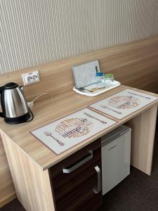 a wooden desk with a laptop on top of it at Hostel Iskra in Lviv
