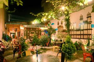 a patio with tables and chairs in a building at Komal Hotel in Lālbhitti