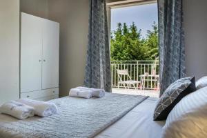 a bedroom with a large bed with towels on it at La SkalaVista in Skala +77 photos