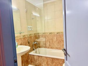 a bathroom with a shower and a sink and a tub at Mountain View Ariz in Al Arz +89 photos