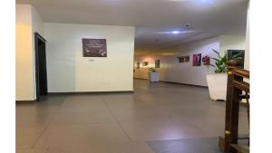 a room with a hallway with white walls at Bromford Hotel Owerri in Owerri