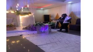 a woman standing at a desk in a room at Bromford Hotel Owerri in Owerri