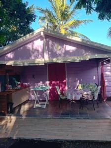 a house with a patio with a table and chairs at Gîte Anolis in Saint-François