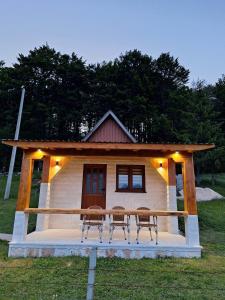 a tiny house with chairs in front of it at Koliba in Žabljak