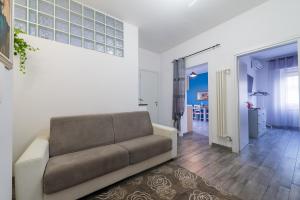 a living room with a couch and a hallway at Di Giuseppe Laura in Ladispoli
