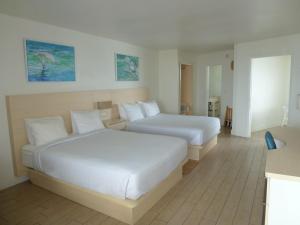 a hotel room with two beds in a room at Chateau Mar Beach Hotel NEWLY REFURBISHED in Ormond Beach +10 photos