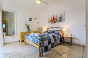 a bedroom with a bed and a mirror at Resitour - Tala Hills in Tala