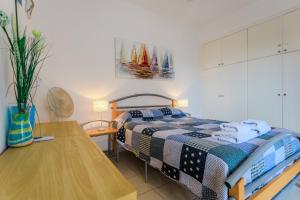a bedroom with a bed and a wooden table at Resitour - Tala Hills in Tala