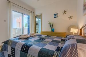 a bedroom with a bed with two towels on it at Resitour - Tala Hills in Tala +12 photos