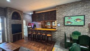 a bar in a restaurant with a brick wall at Ngandu at Sea in Meersig
