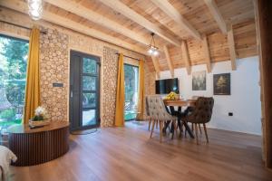 a dining room with a table and chairs at Green Hideaway SPA in Žabljak