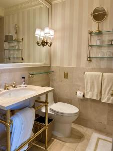 a bathroom with a toilet and a sink and a mirror at The Hay - Adams in Washington, D.C. +17 photos