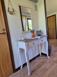 a white dressing table in a room with a mirror at Ferienhaus Stensjö in Holmsjö