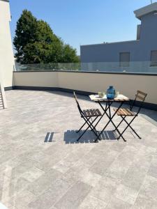 a table and two chairs on a patio at Il Matisse in Dosso
