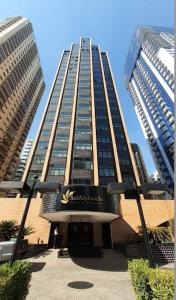 a tall building with a sign in front of it at Hotel Sol Alphaville in Barueri