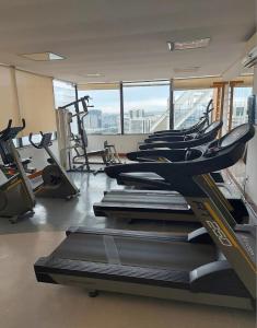 a gym with rows of treadmills and machines at Hotel Sol Alphaville in Barueri
