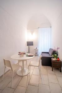 a living room with a table and a couch at Il Da Vinci Apartment in Giovinazzo +36 photos