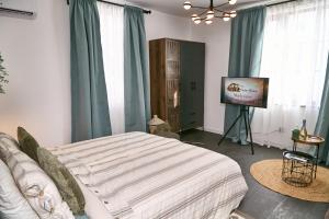 a bedroom with a bed and a television in it at Gatev House in Teteven +37 photos