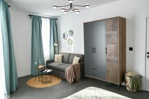a living room with a gray couch and a large cabinet at Gatev House in Teteven